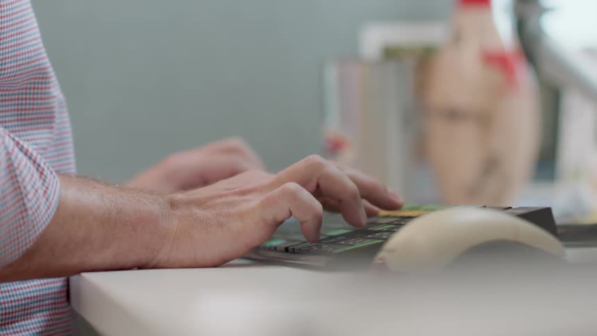 A person is sitting down typing on a keyboard