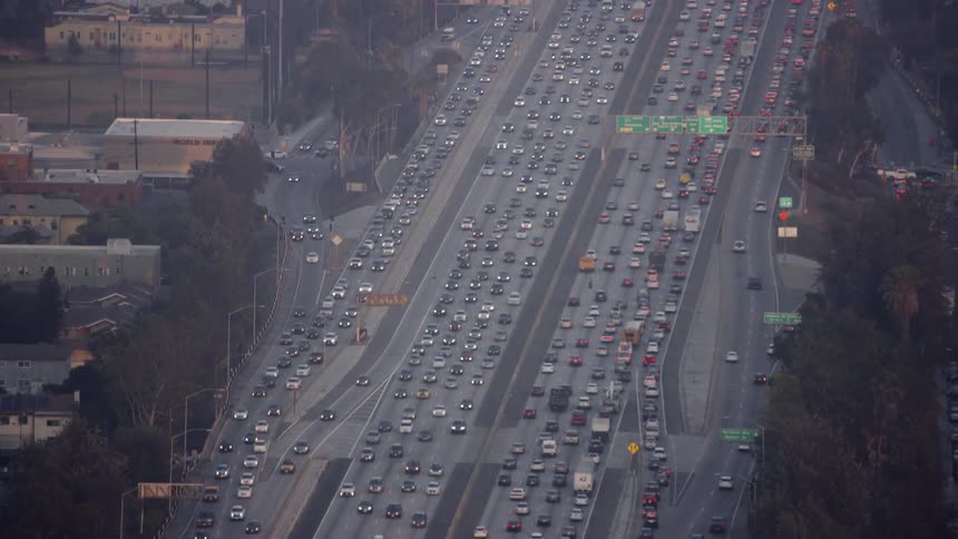 Cars drive on a city highway