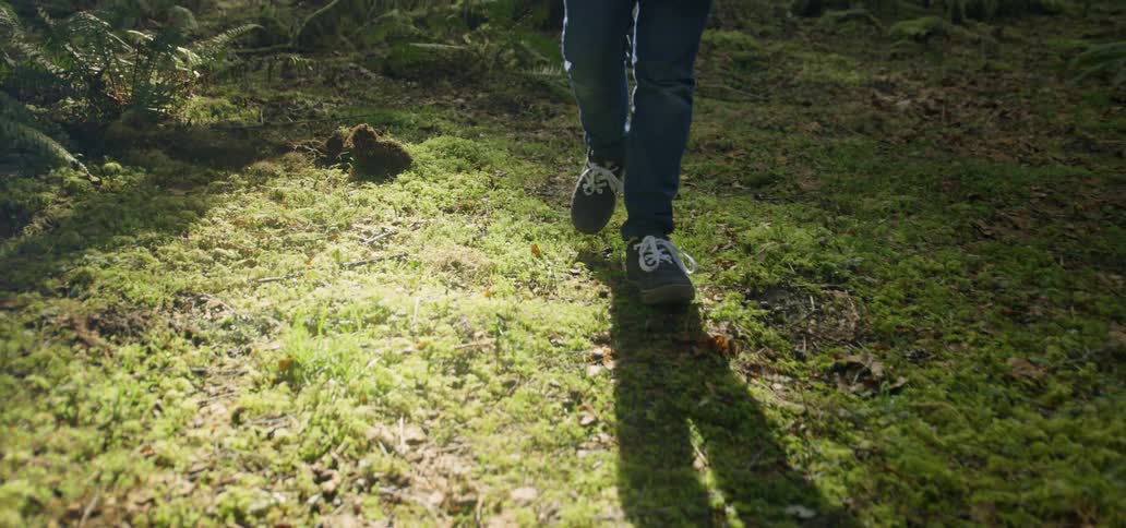 A person walks on the grass outside