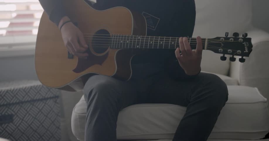 A man plays an acoustic guitar