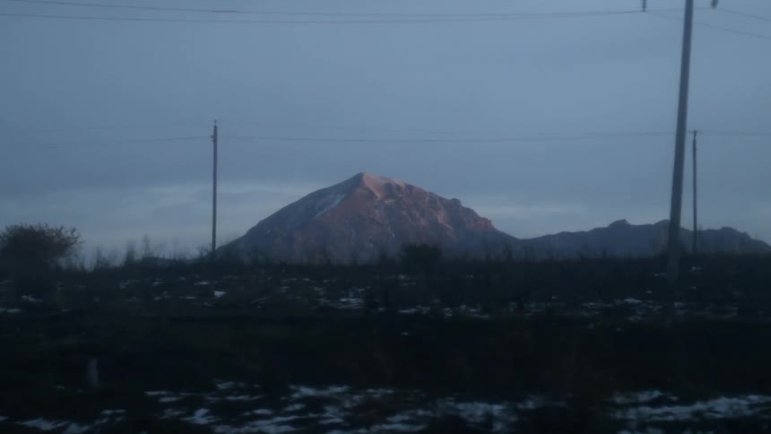 A tall mountain towers into the sky