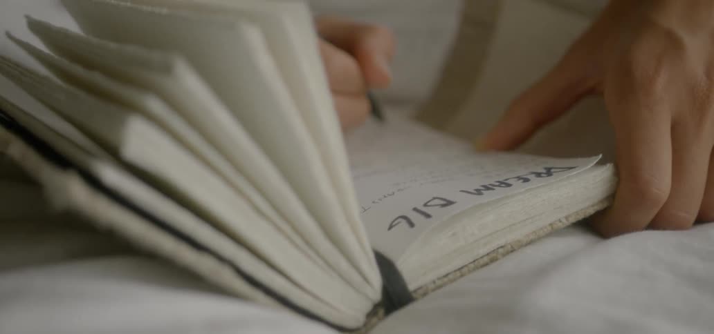 A woman writes in a journal