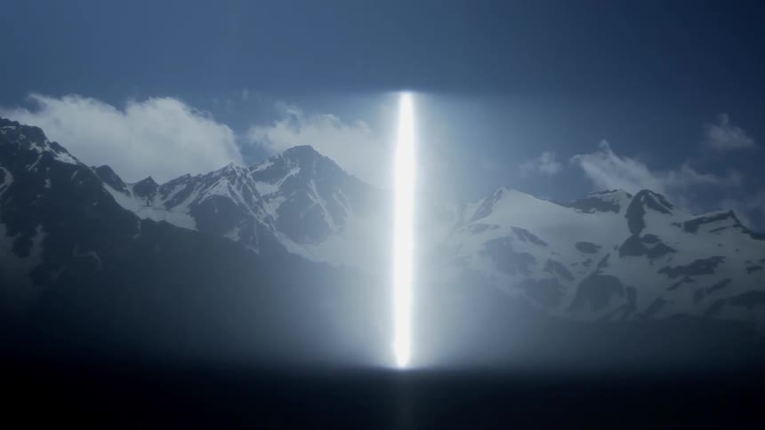 Reflection of sunlight over snowy mountains