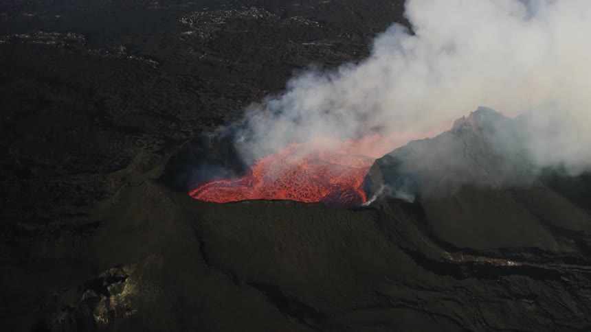 Lava slowly flowing as smoke comes off