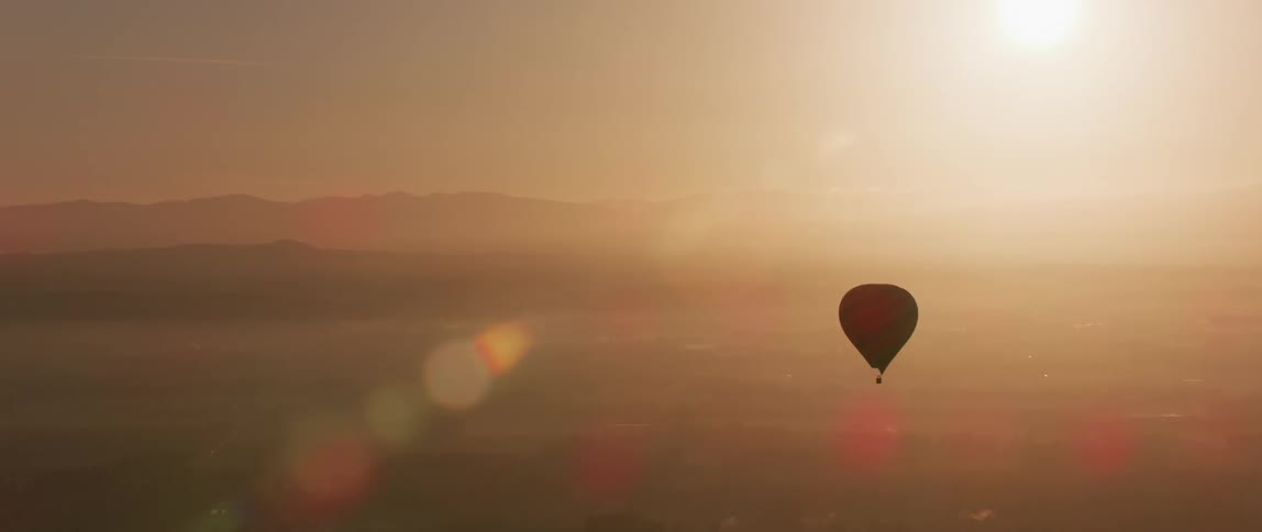 A hot air balloon floats in the sky