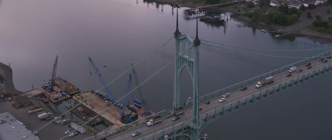 Vehicles travel over a city bridge