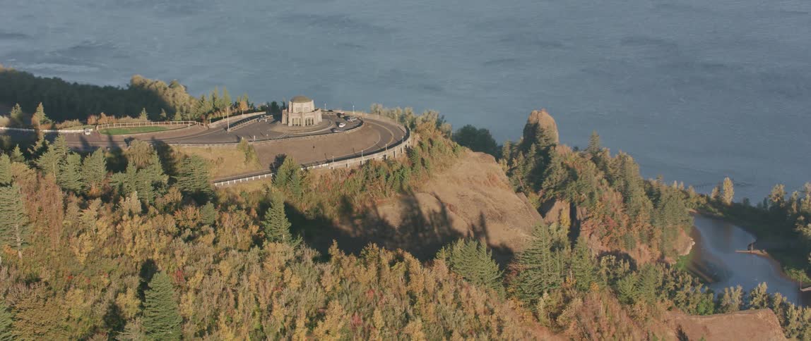 A building sits on a roundabout on a mountain road