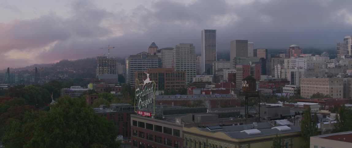 A portland oregon sign sits on top of a city building