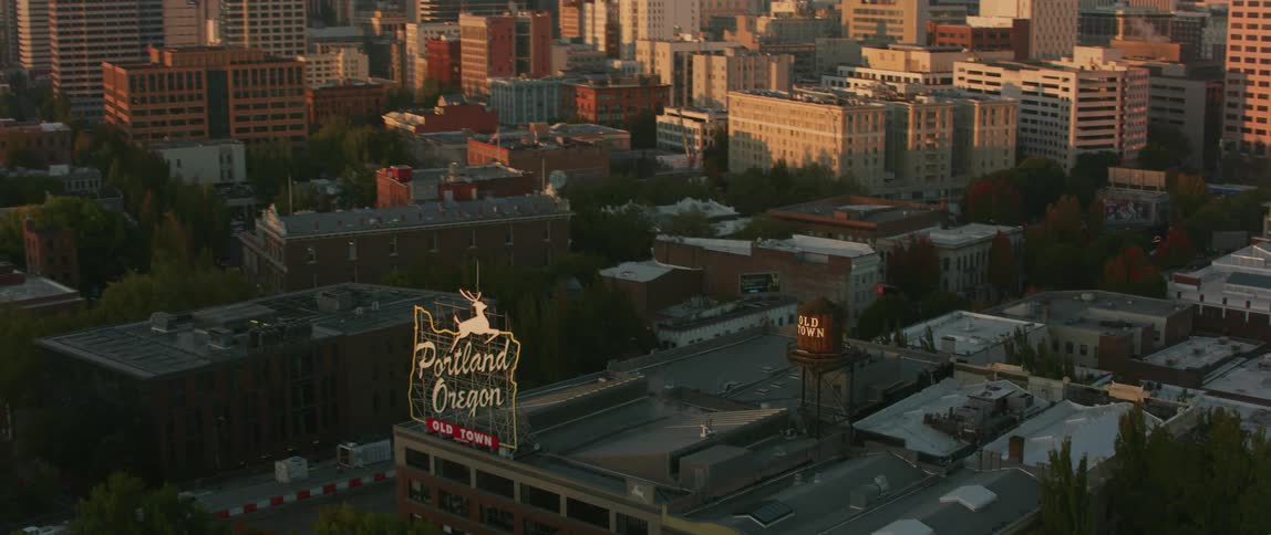 A sign for portland is displayed on the side of a building