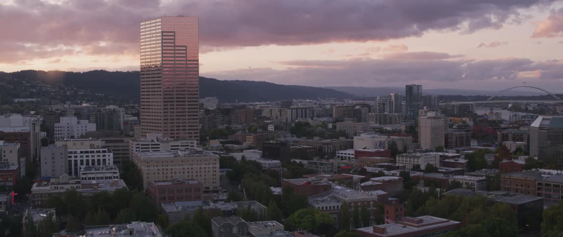 Buildings stand in a city at sunrise