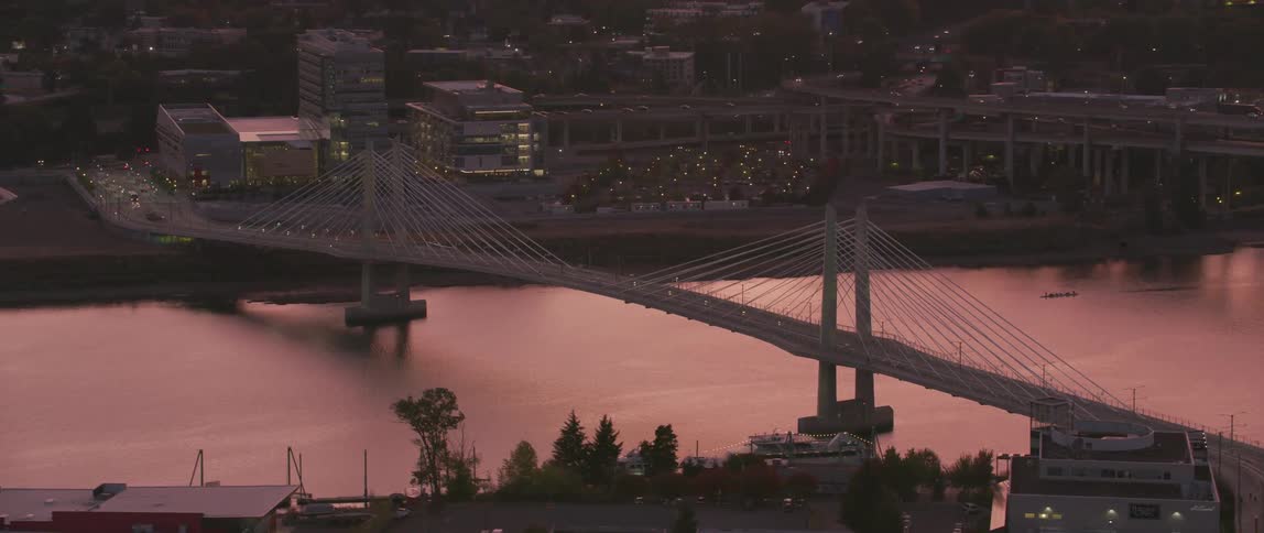 Lights illuminate the side of the bridge