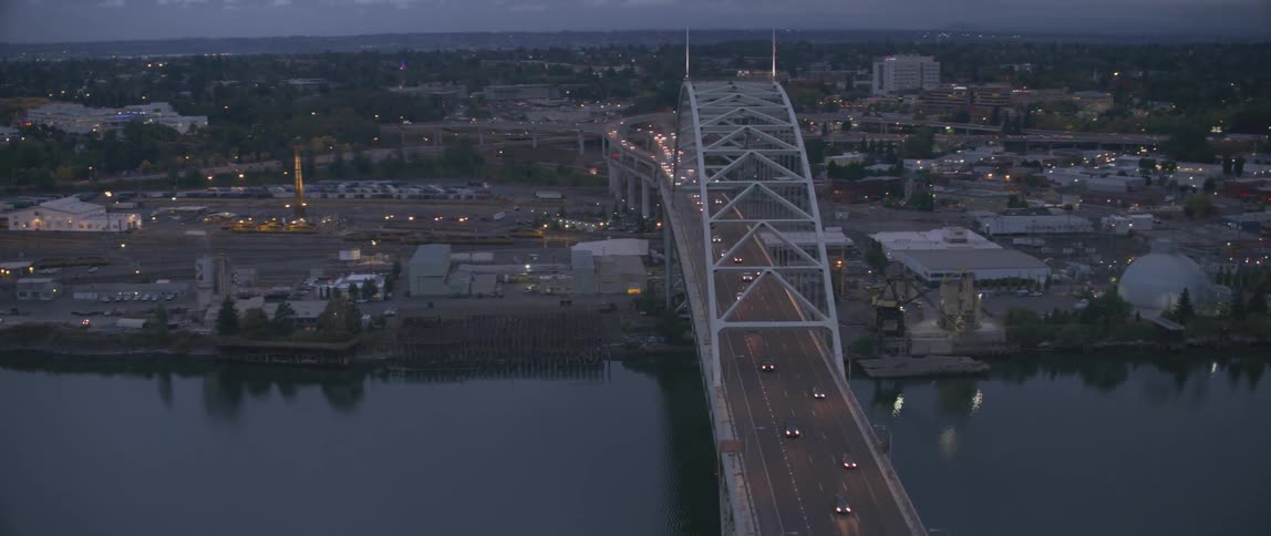 Vehicles travel over a city bridge