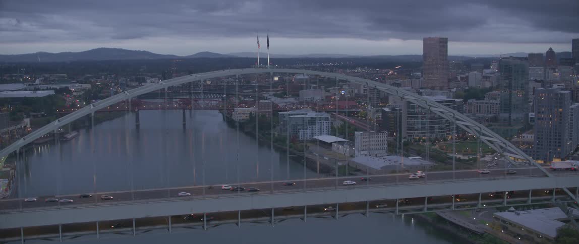 Cars and trucks travel across a city bridge in both directions