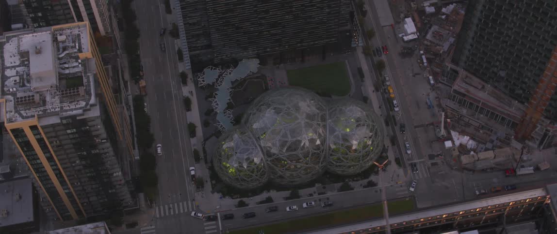 A glass domed building sits in a city