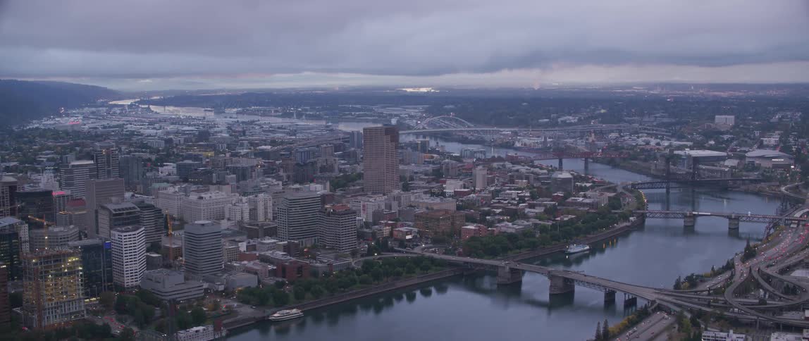 A river flows through a city on a cloudy day