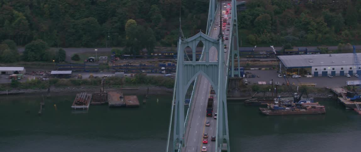 Vehicles travel over a city bridge