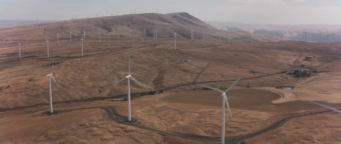 Windmills spin in a large open field
