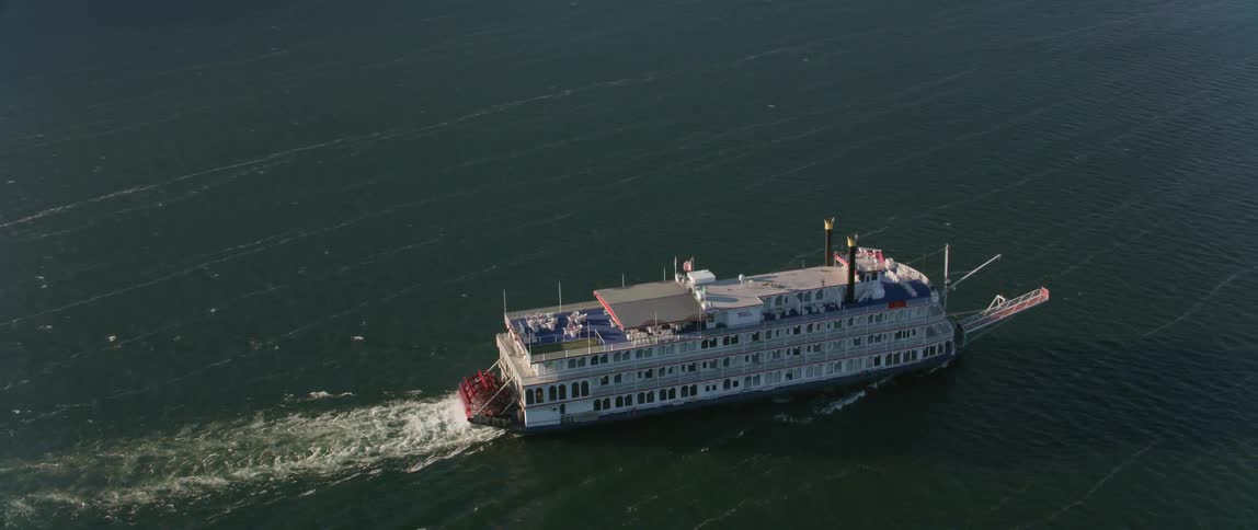 A ferry travels through the water leaving a wake