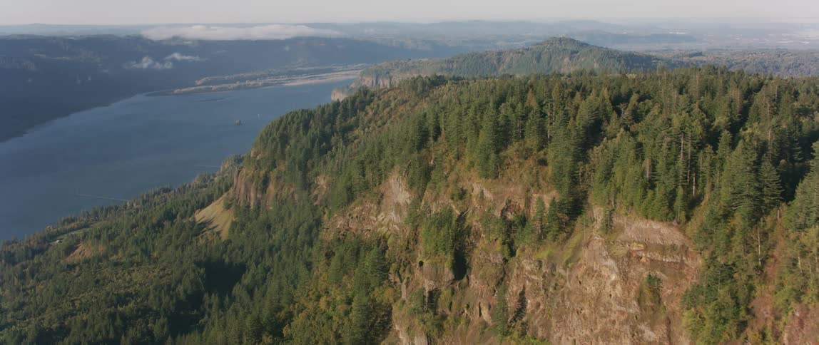 Trees cover the landscape on top and around mountains
