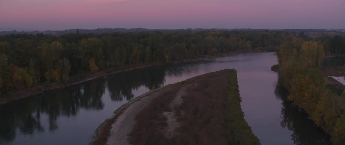 Trees line each side of the river