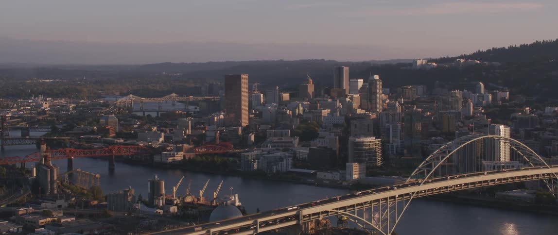 Cars drive across a city bridge