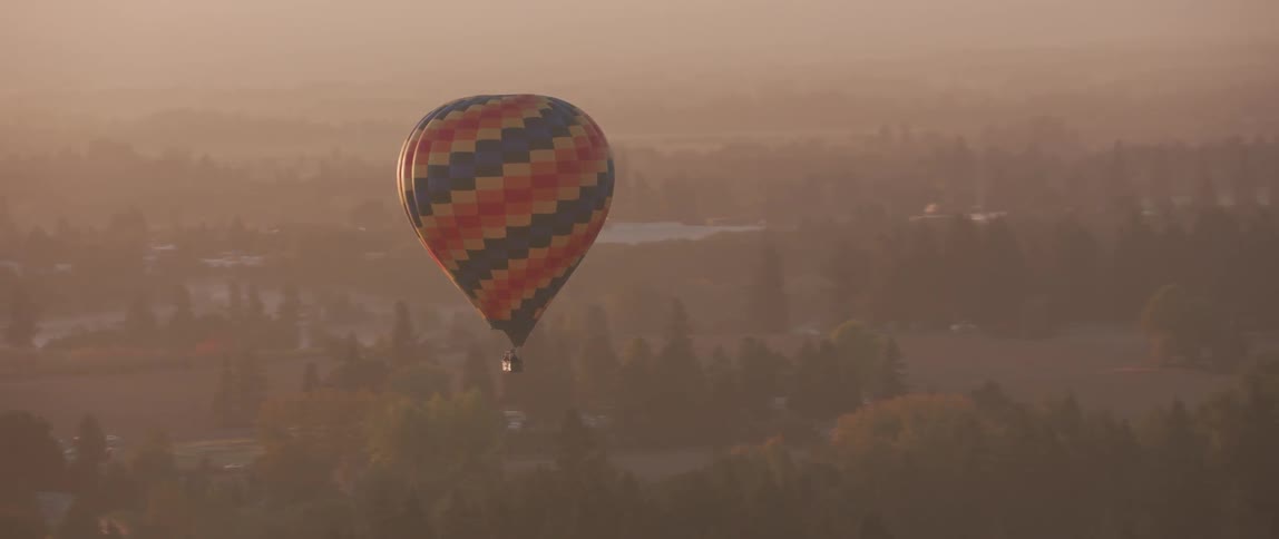 A hot air balloon floats in the sky