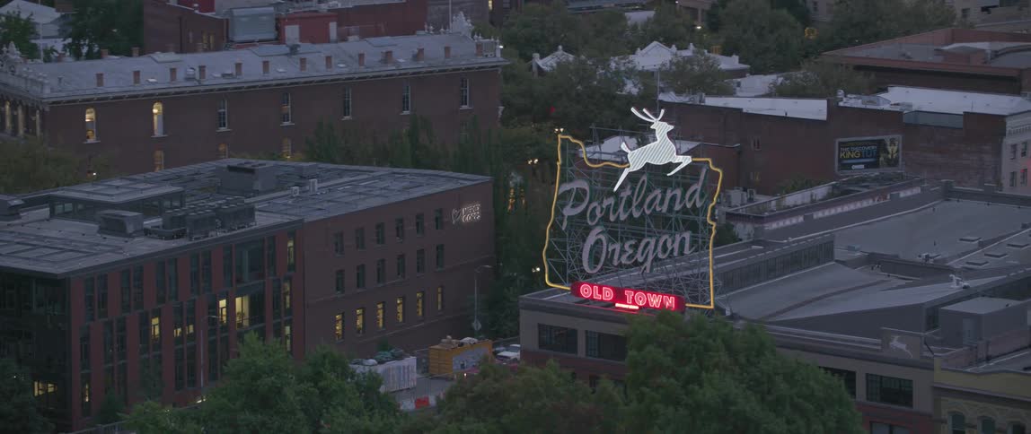 Building with a large neon sign in a big city