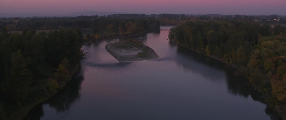 Trees are reflected in the river water