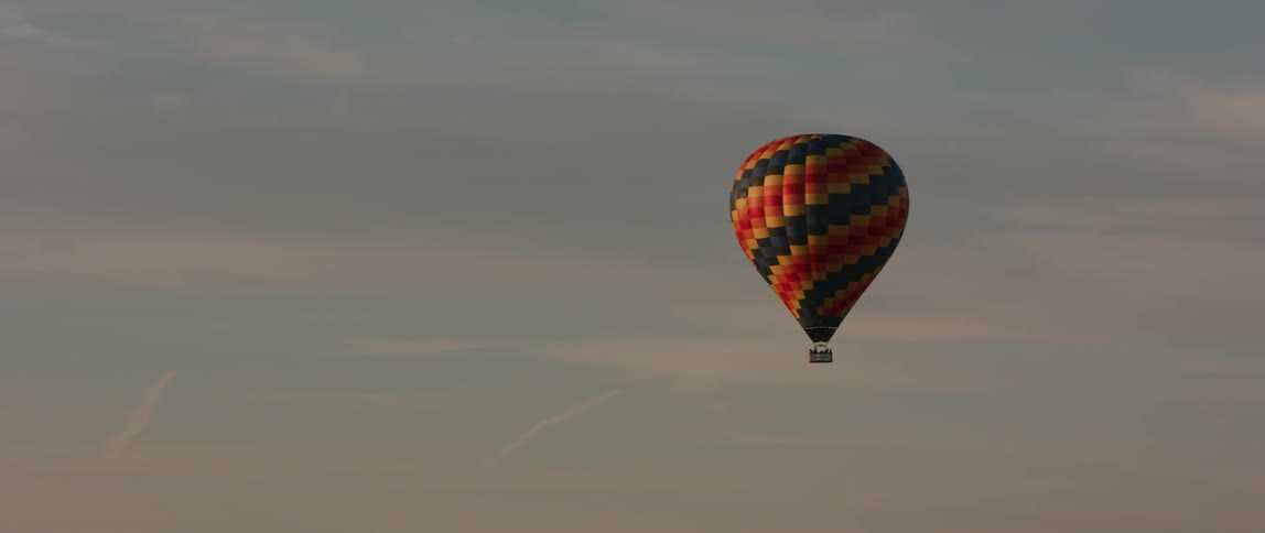 A hot air balloon floats in the sky