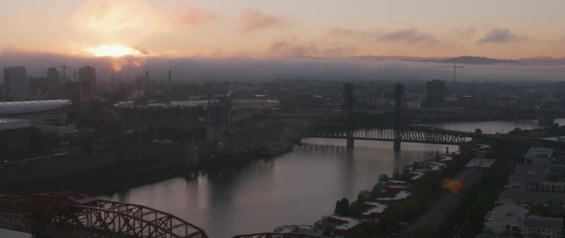 The sun shines on city bridges as vehicles travel