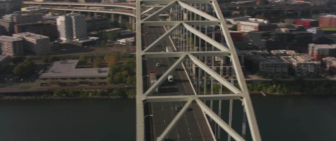 Vehicles travel over a city bridge