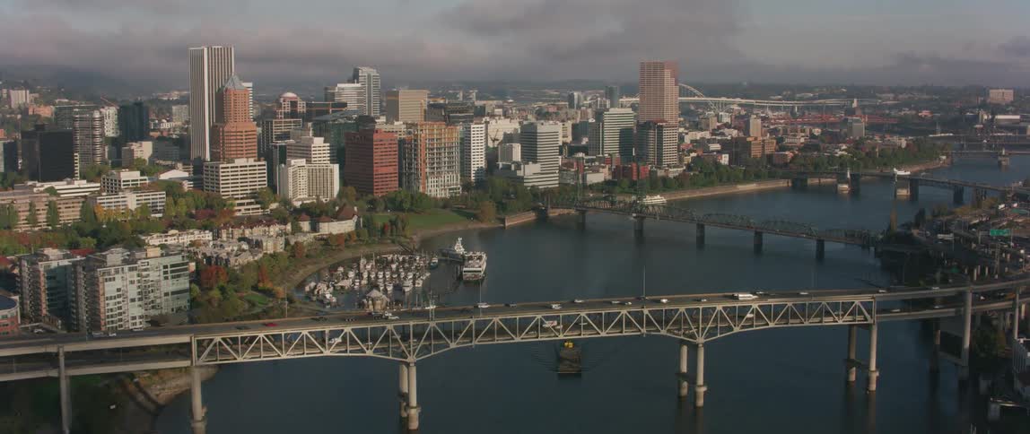 Vehicles travel over a city bridge.\