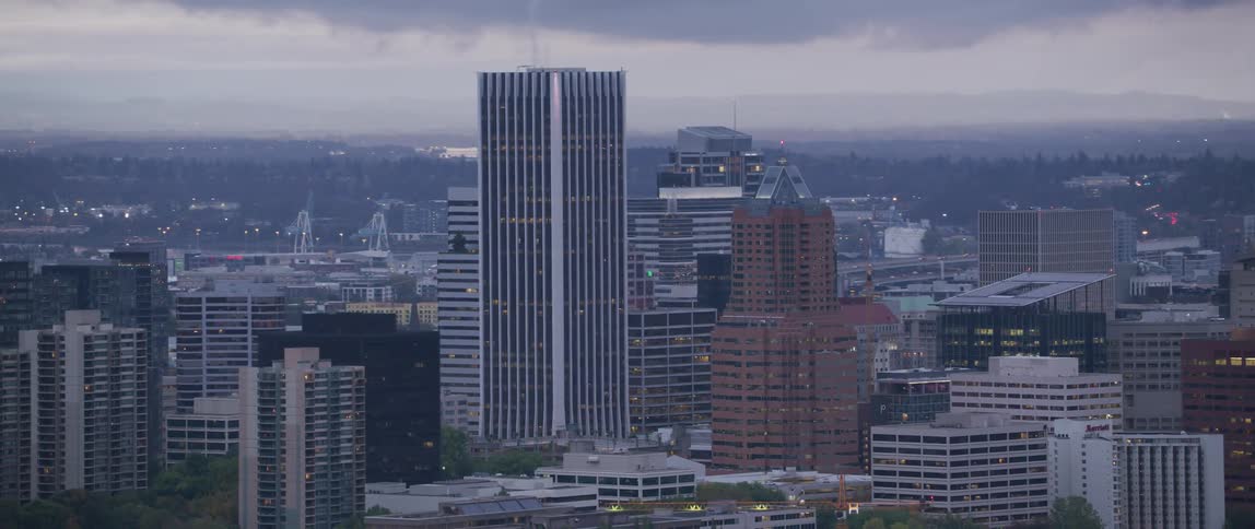 Skyscrapers stand in a city at sunrise