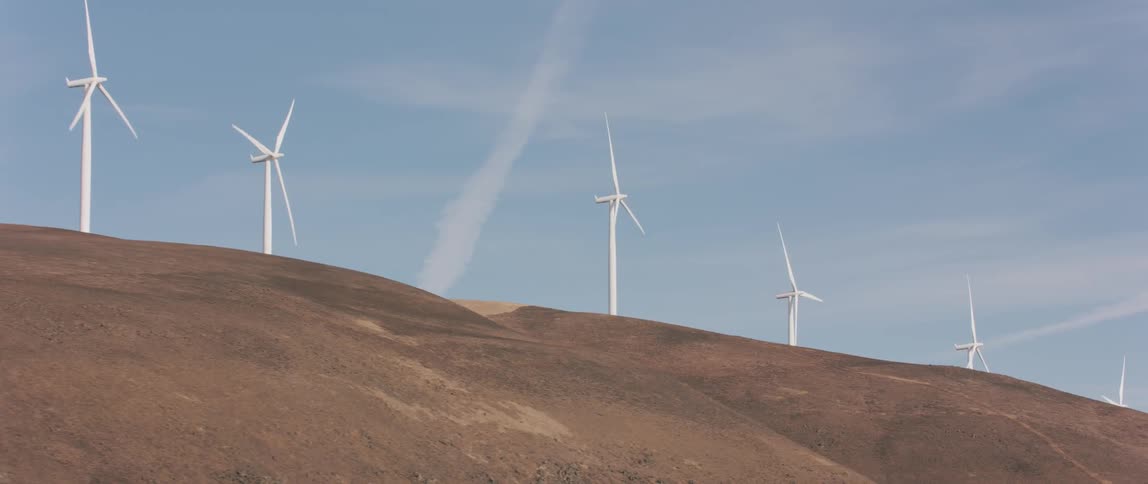Windmills spin atop a hill