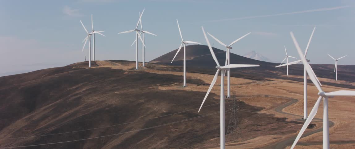 Windmills spin in a large open field