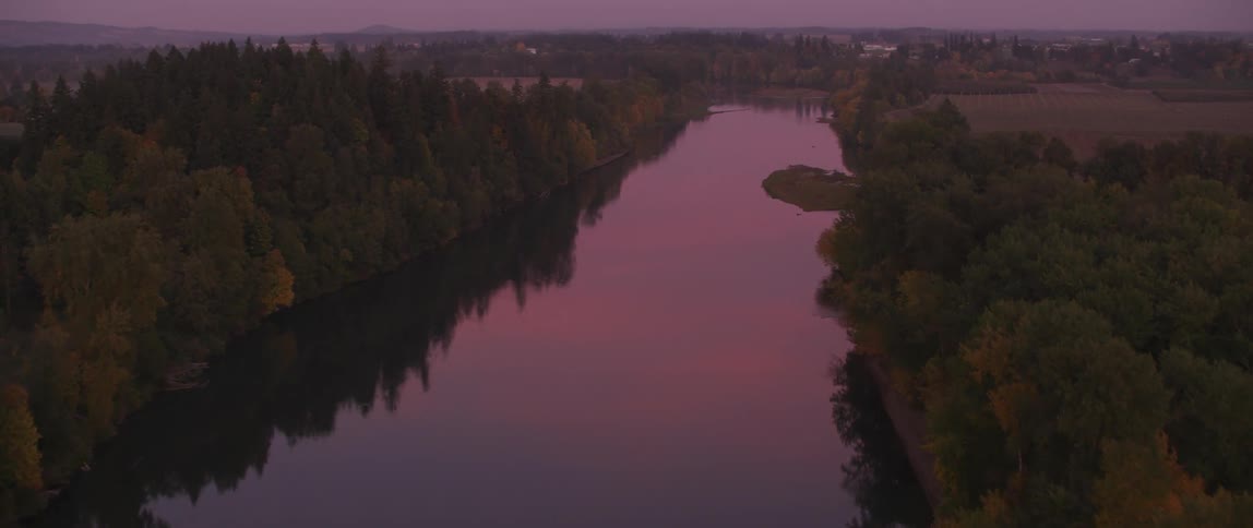 River winding through a town near sunset