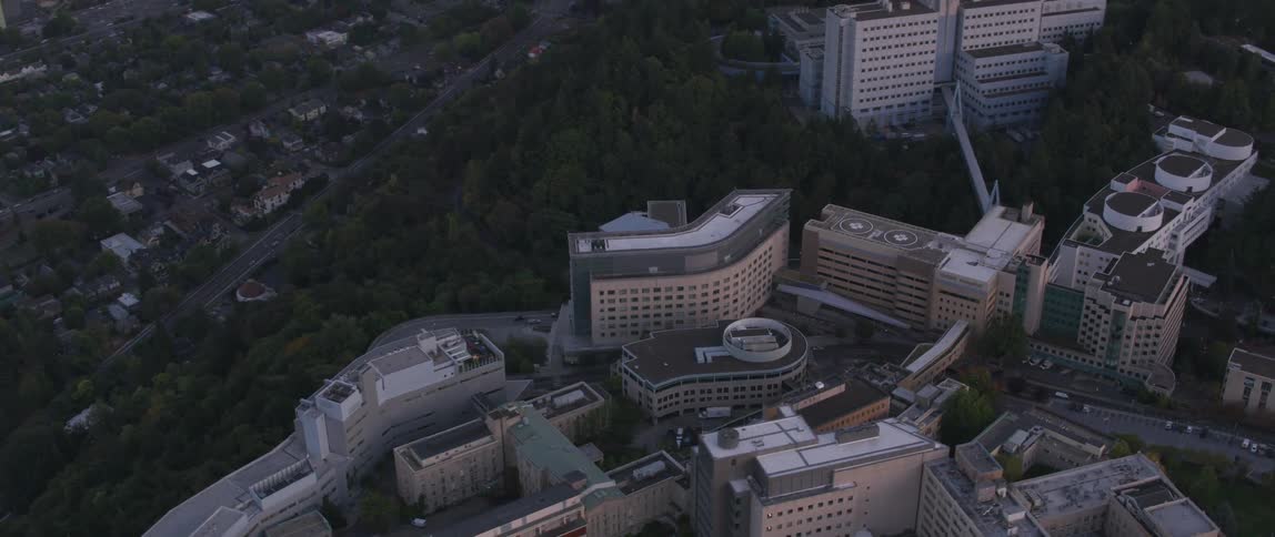 A complex of buildings sits atop a cliff