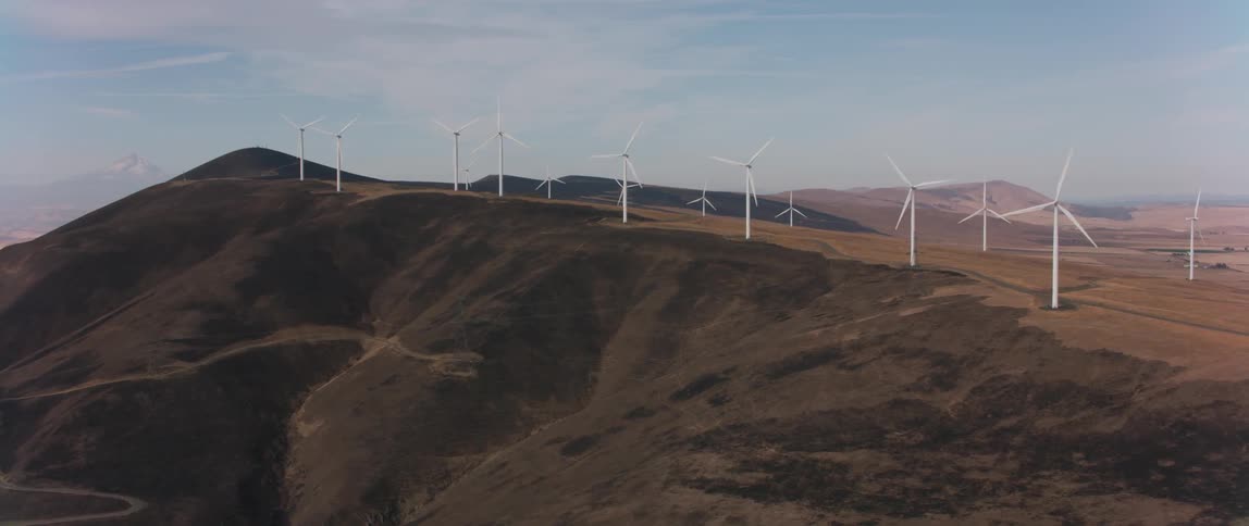 Windmills spin in a large open field