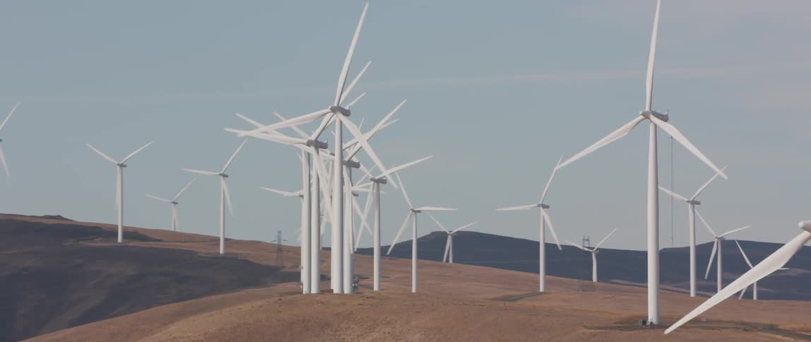 Wind turbines spin on a hill