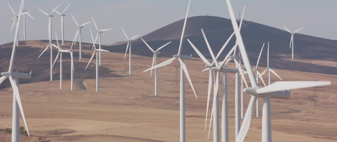 Windmills spin in a large open field