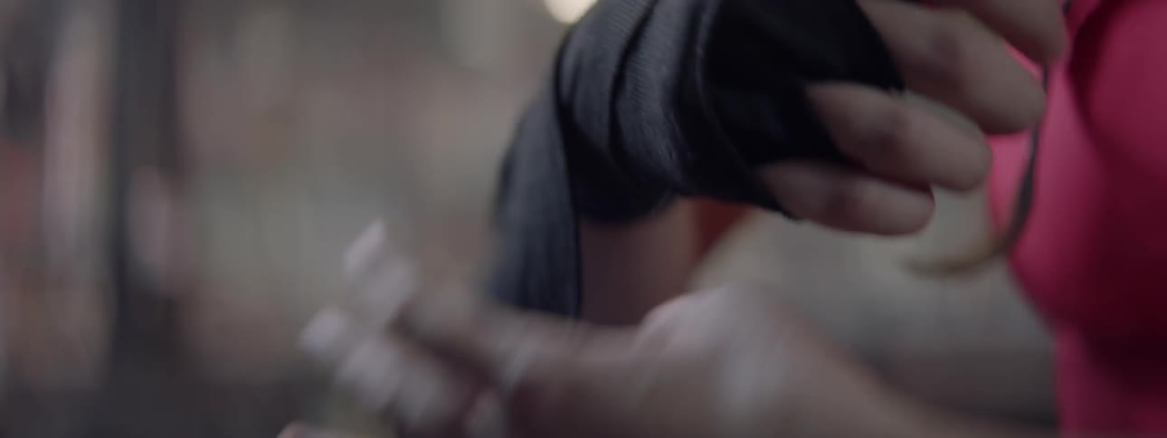 Woman wraps a bandage around her hand