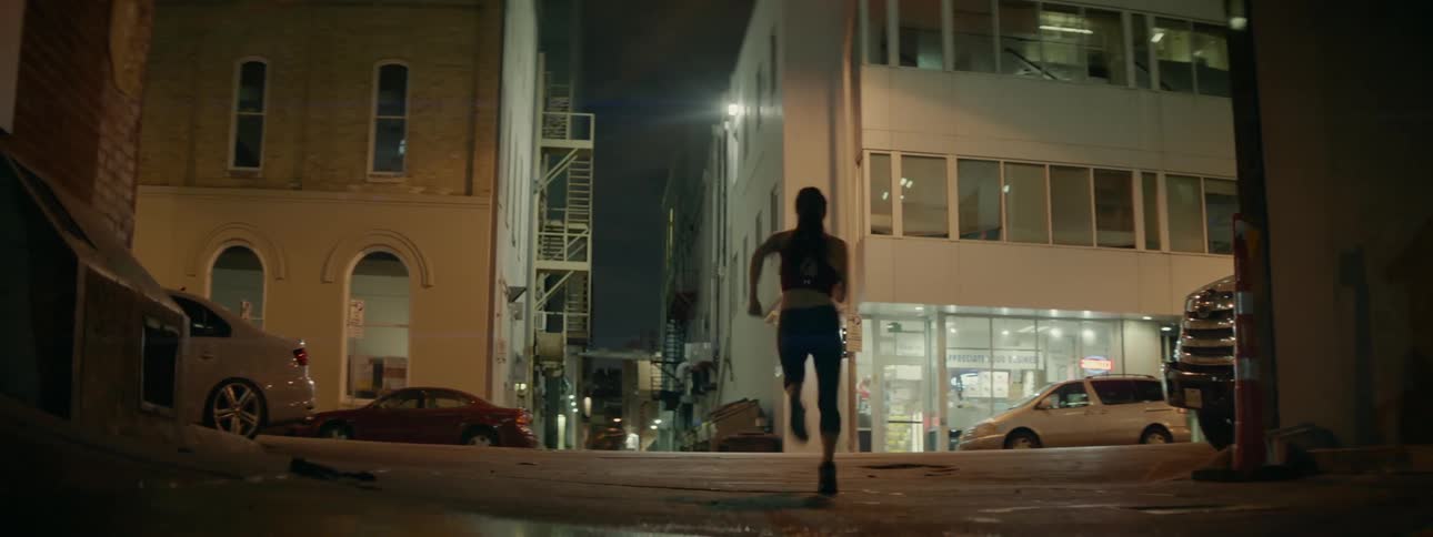 A woman jogs down the street