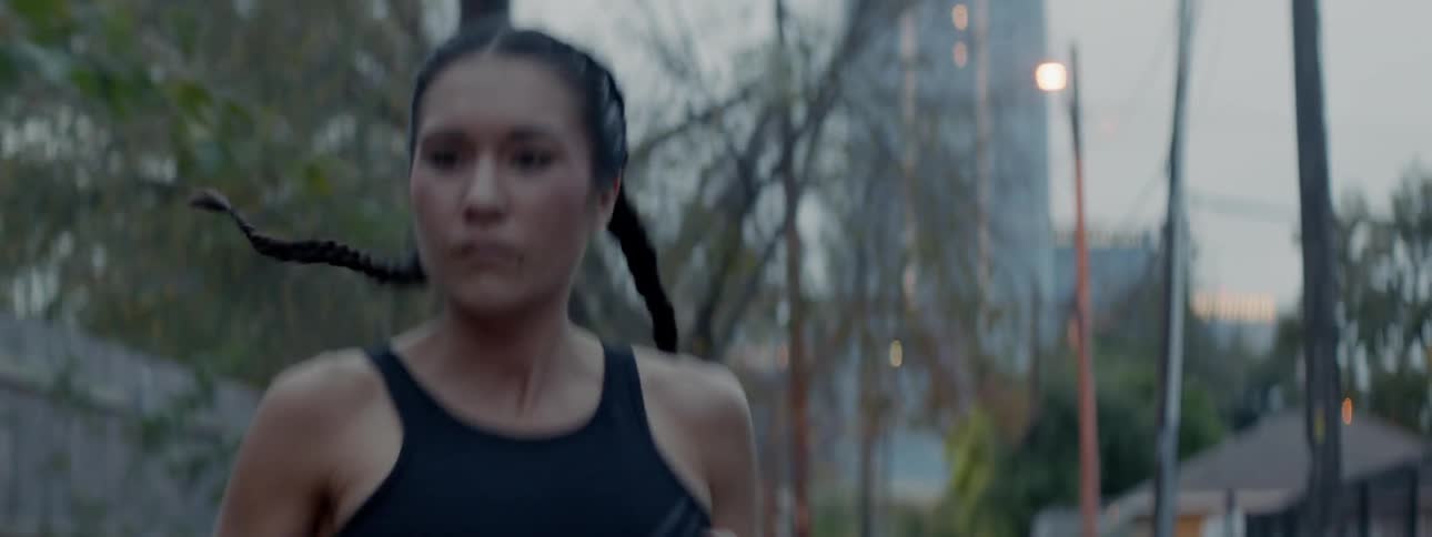 Woman jogs through the city park