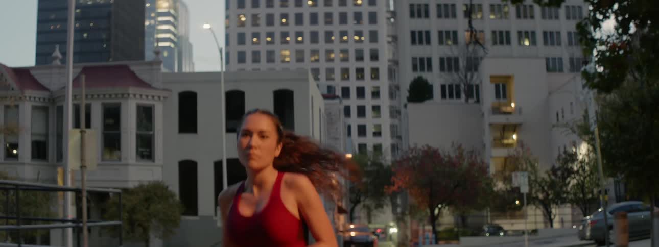 A woman jogs down the street