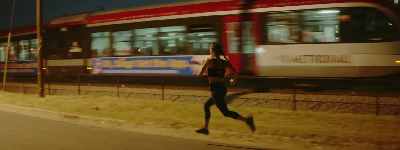 A woman jogs down the street