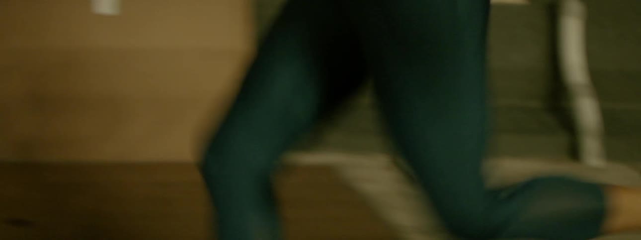 A woman jogs on a sidewalk