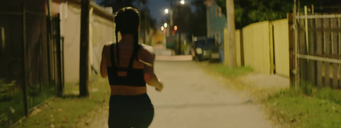 A woman jogs down the alleyway