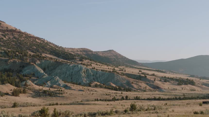 Trees and rocks cover a mountain landscape