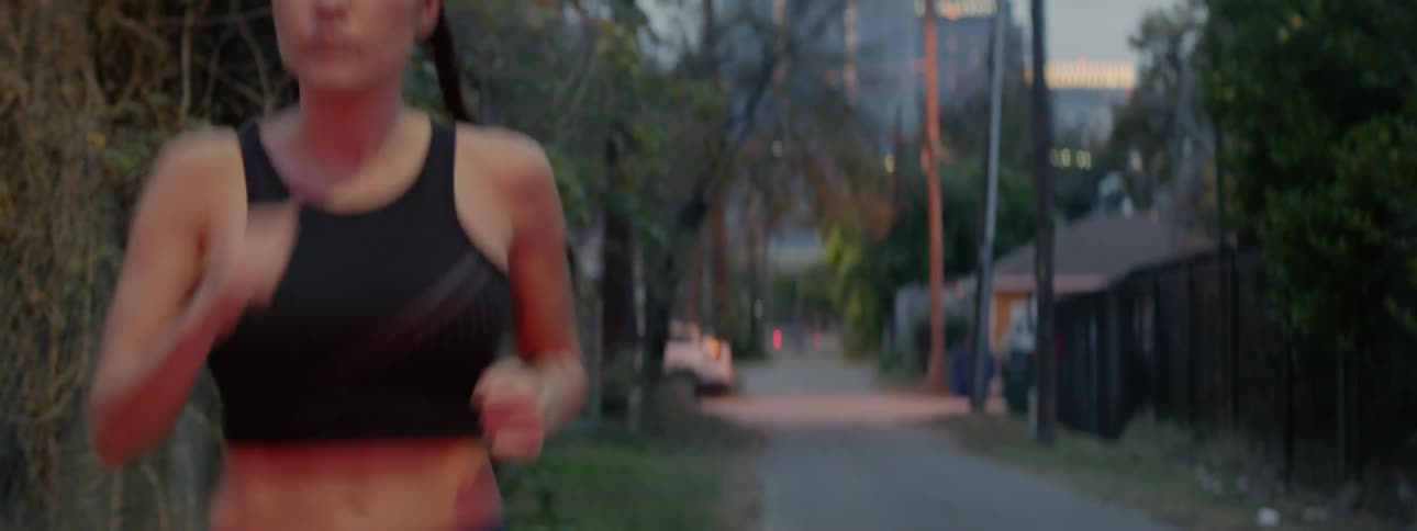 A woman jogs down an alleyway