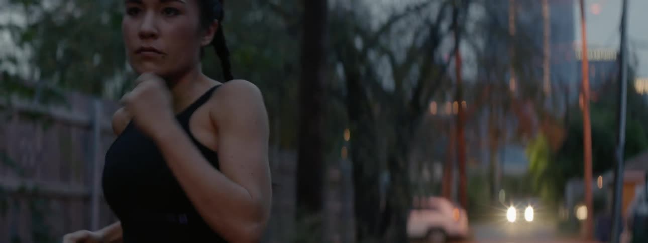 A woman jogs down the street